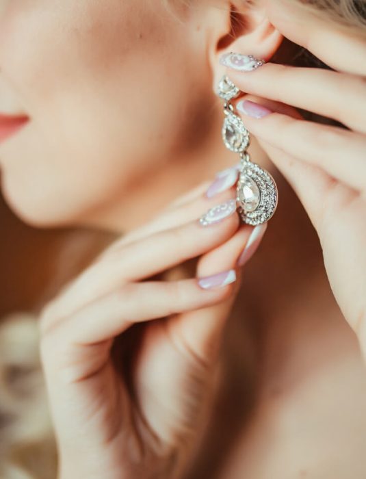 wedding-preparation-beautiful-happy-bride-dresses-earrings-before-wedding (1)